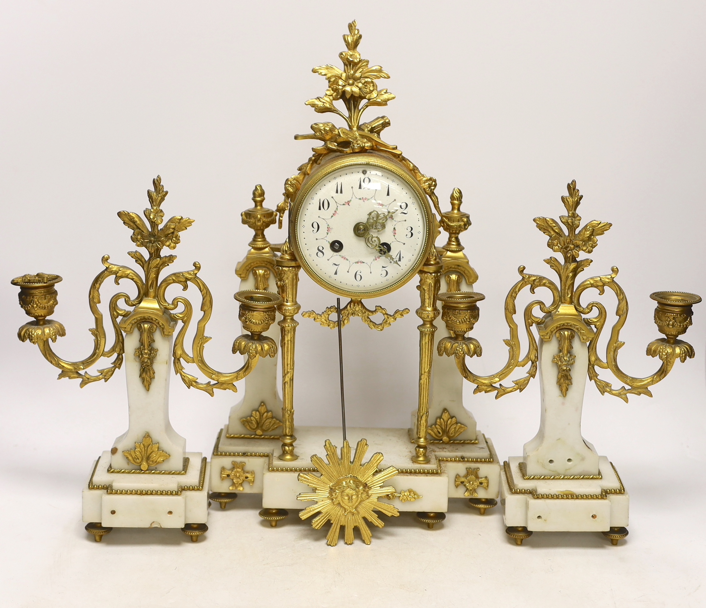 An early 20th century white marble and ormolu clock garniture with Arabic enamelled dial, 42cm high